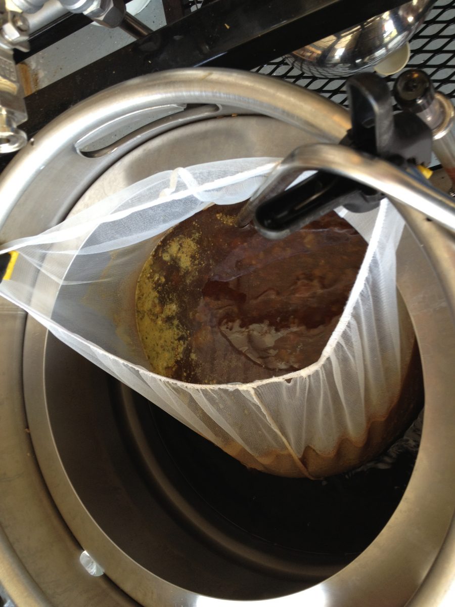 I run through a pump into the paint strainer bag, which holds all of my hops, including the boil hops. This catches most of the hot break, as well as any cold break if I cool during recirc.