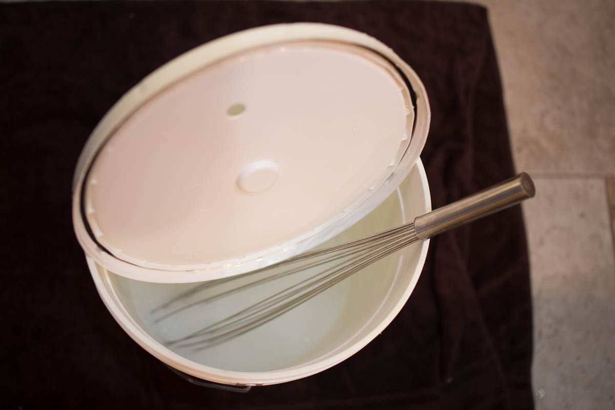 Cleaned and sanitized fermenter and whisk