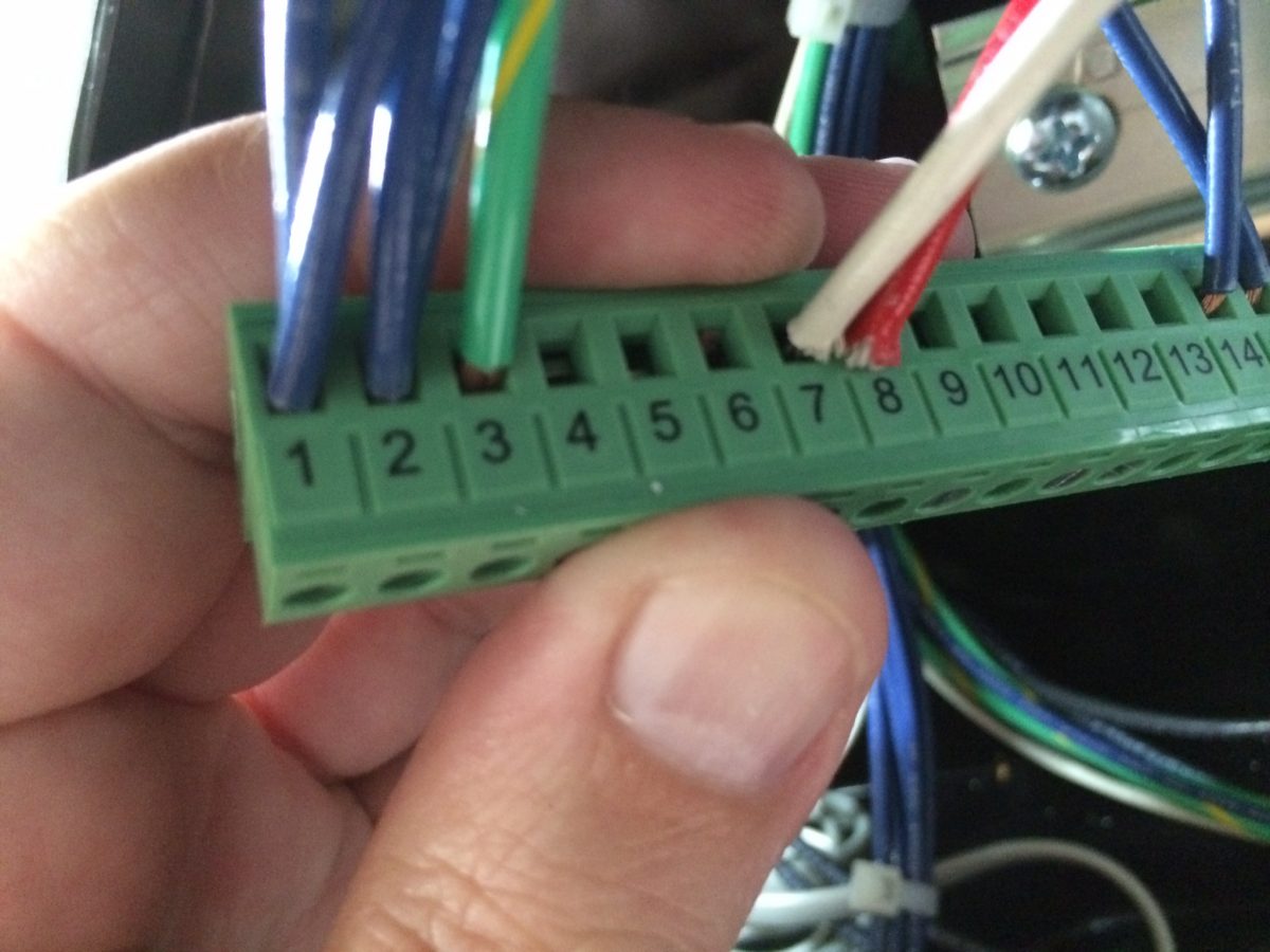 Confirm that the wires are properly installed and correctly seated. Then you can place this wiring strip back onto the PLC. Make sure it is seated firmly with no space left on the lip of the block.