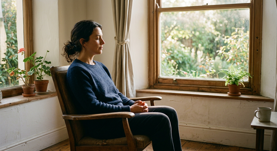 A person sitting quietly by a window in soft morning light, symbolizing the Prayer of Recollection and returning scattered at