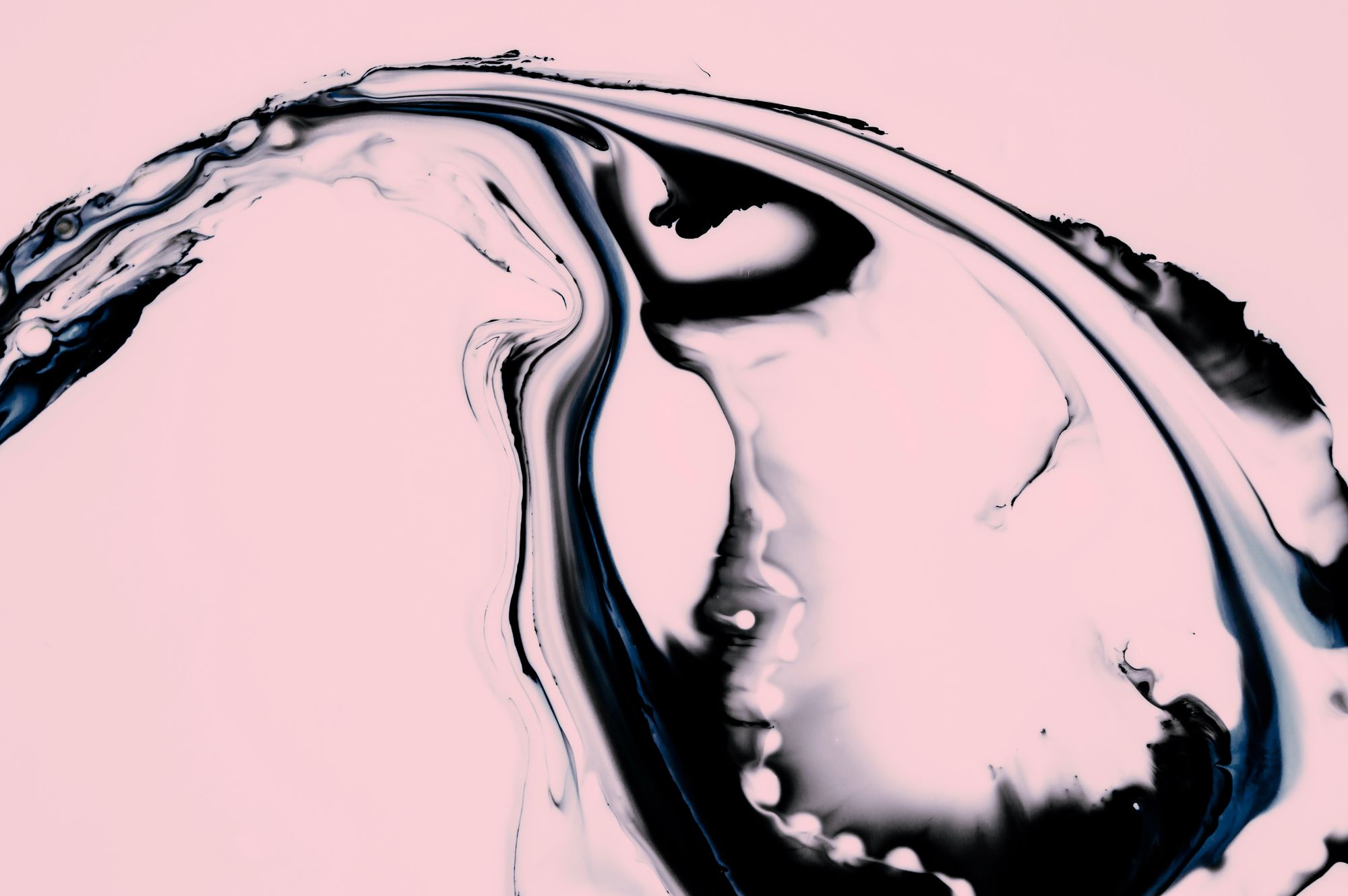 a close up of a liquid substance on a pink background