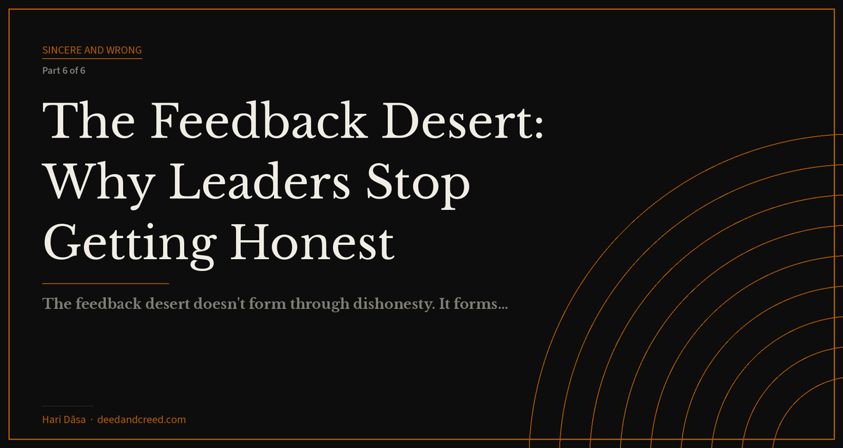 A lone leader at a desk surrounded by empty chairs — representing the isolation of the feedback desert