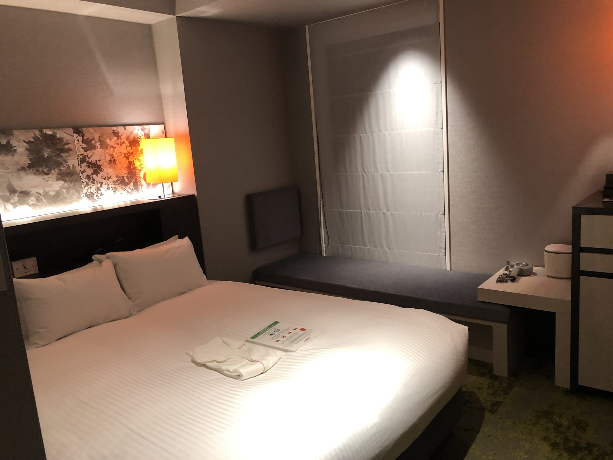 A double room at Hotel Forza Kyoto Shijo Kawaramachi, with a floral art panel above the bed and a window bench
