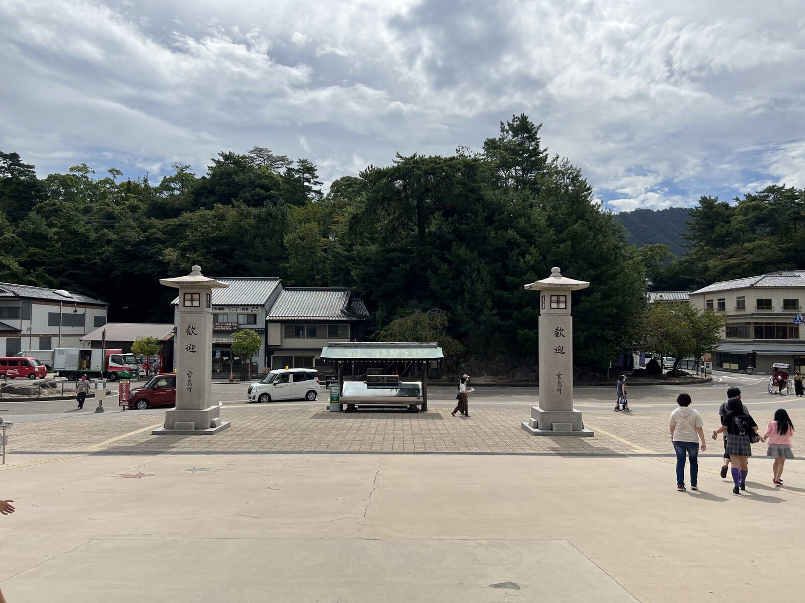 Miyajima island approach with stone lanterns and mountain backdrop