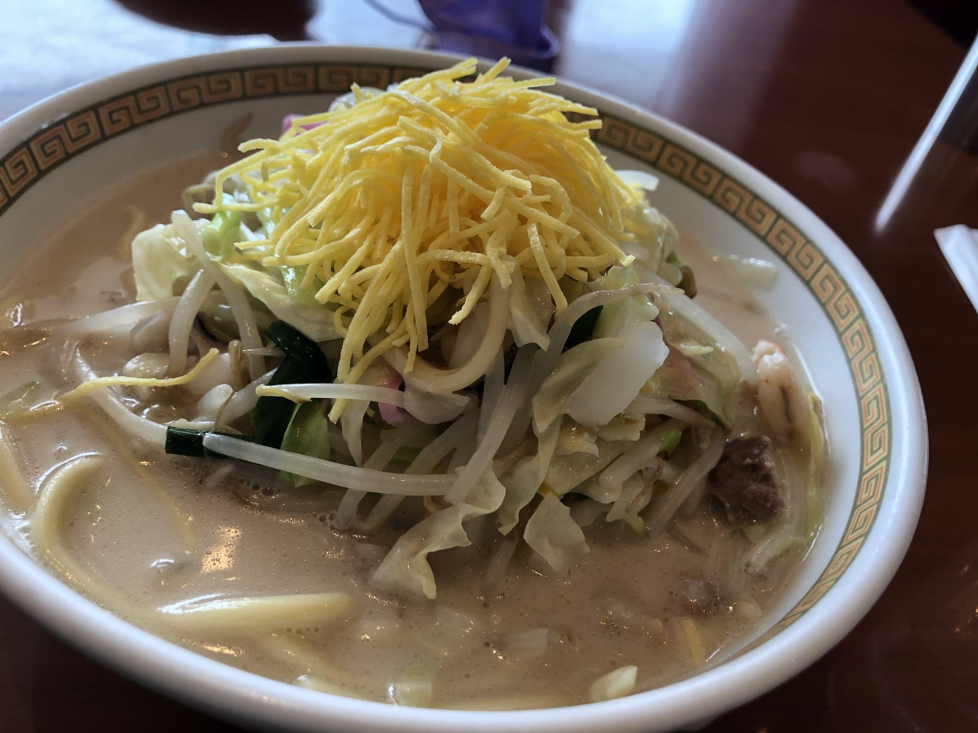Bowl of Nagasaki champon topped with vegetables and seafood