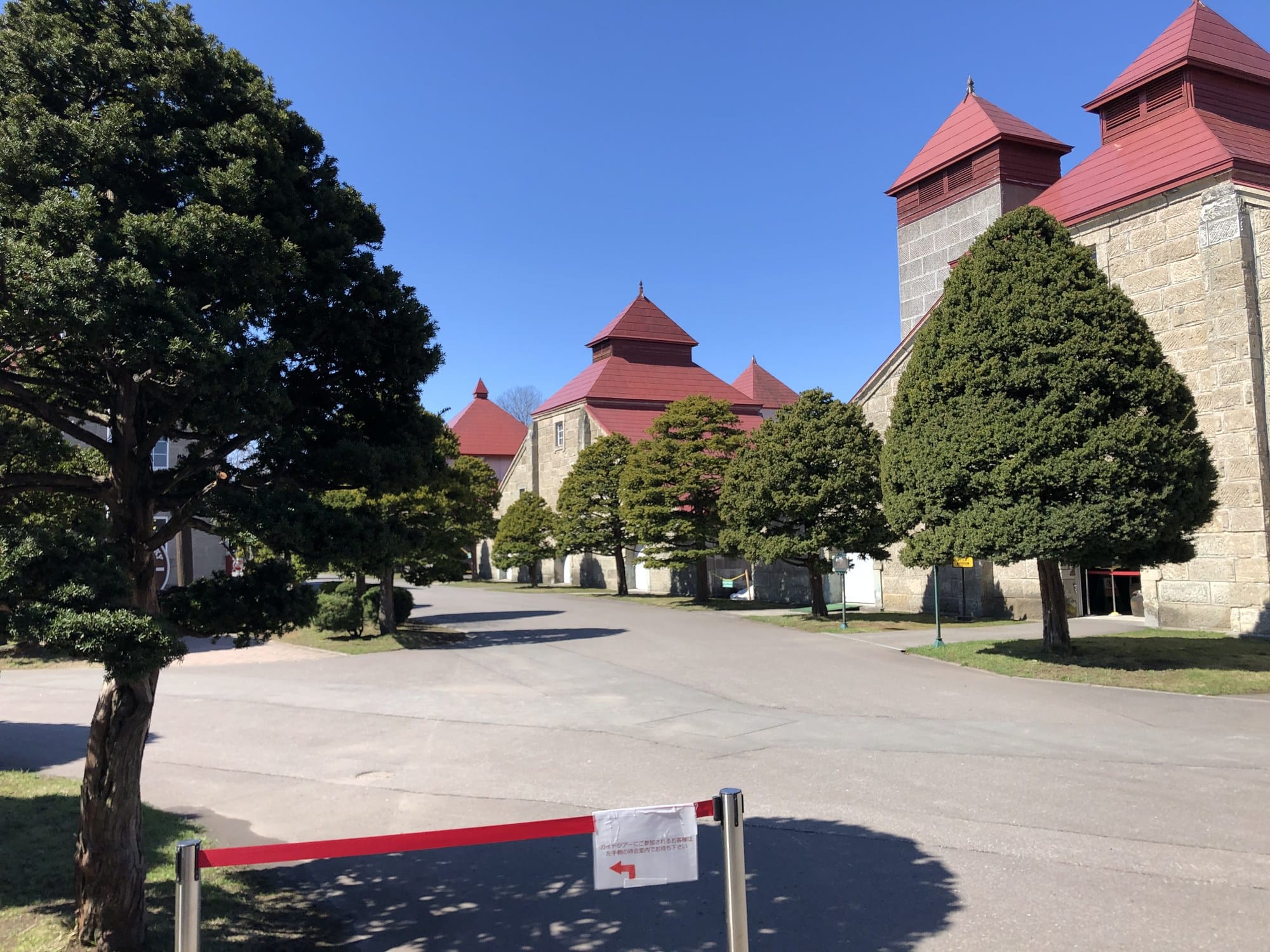 Stone warehouse buildings with red pagoda-style kiln roofs on the Yoichi Distillery grounds