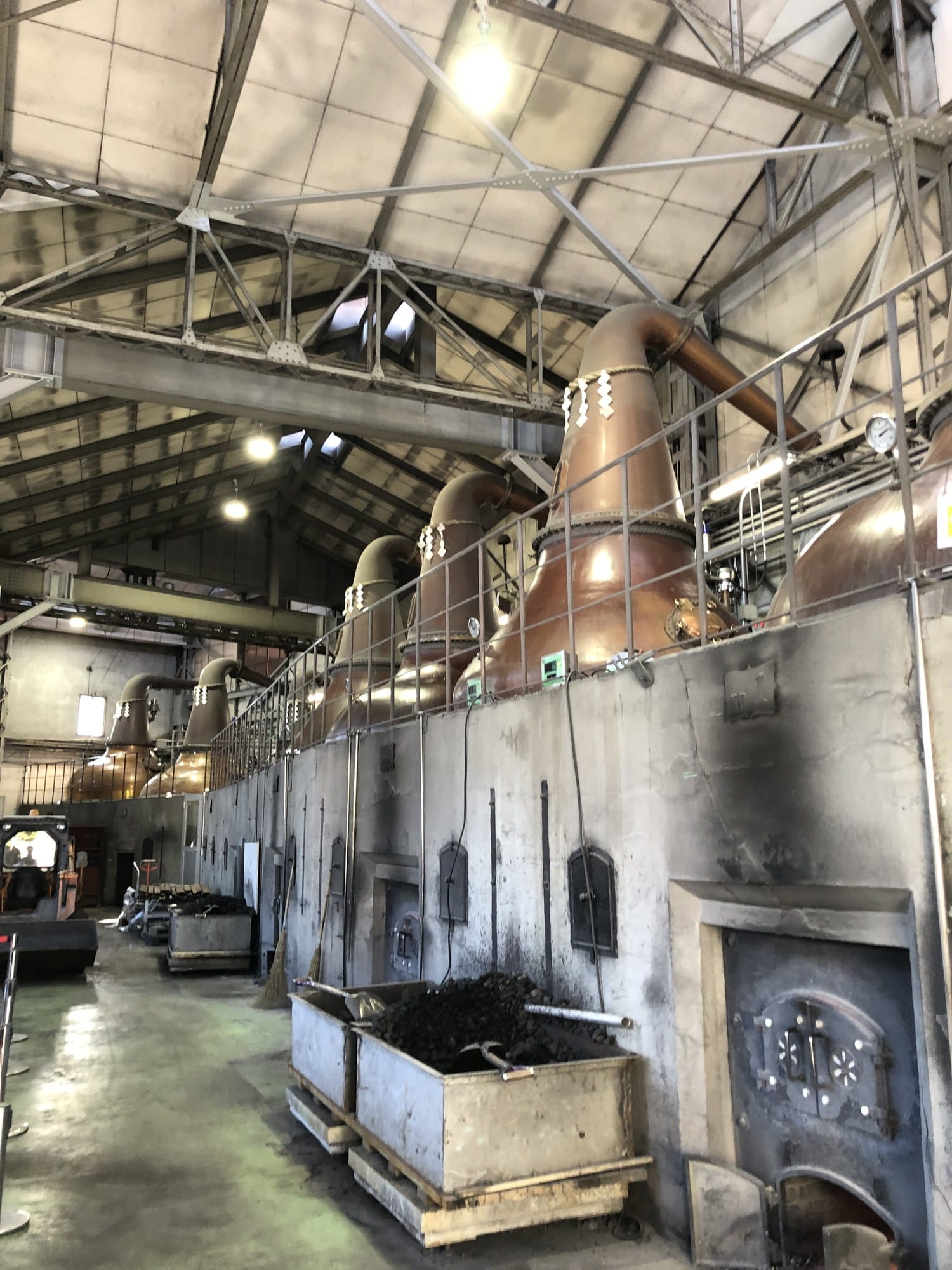 Copper pot stills and coal furnaces inside the Yoichi Distillery stillhouse