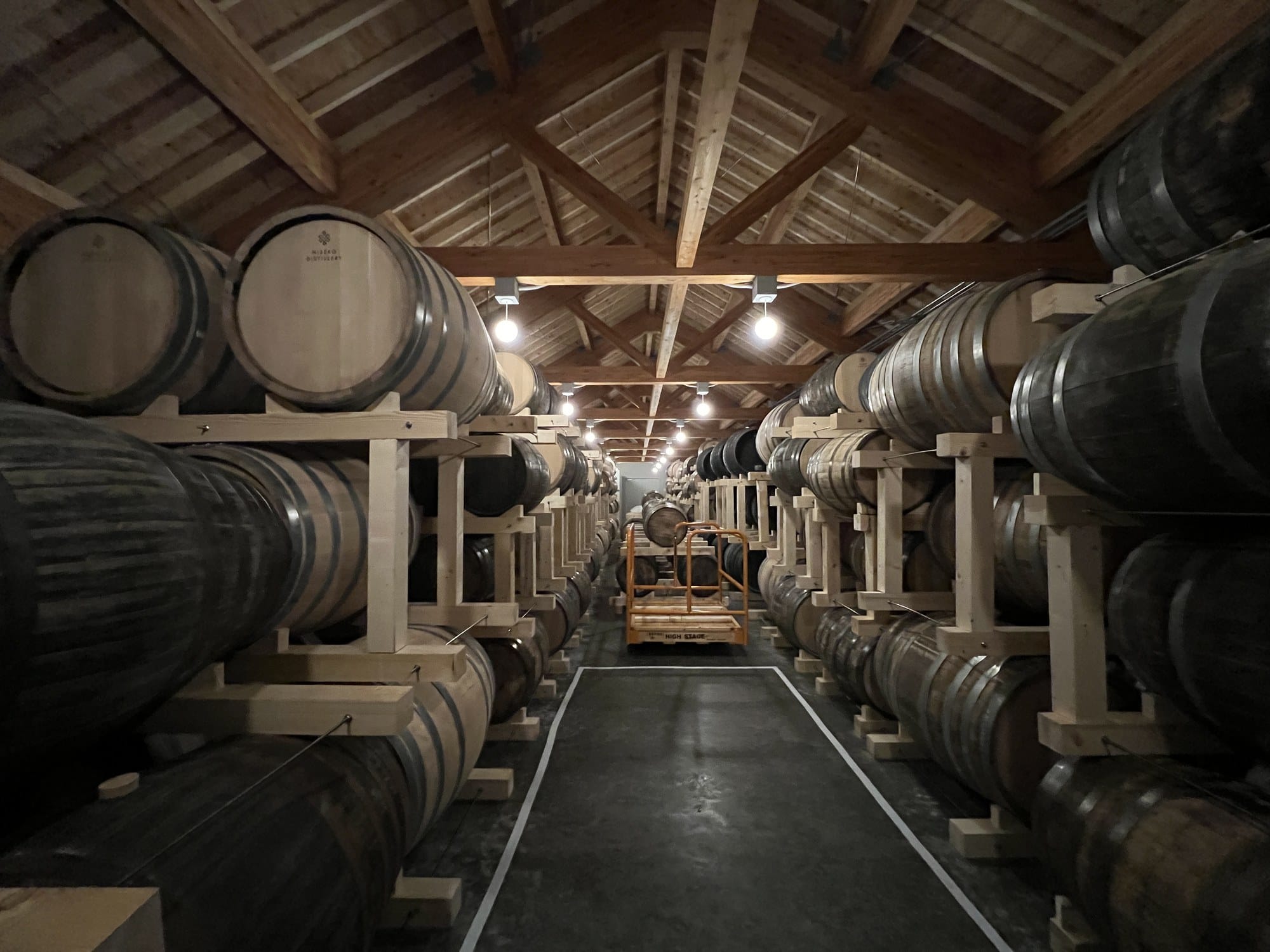 Rows of whisky casks maturing in the barrel cellar at Niseko Distillery
