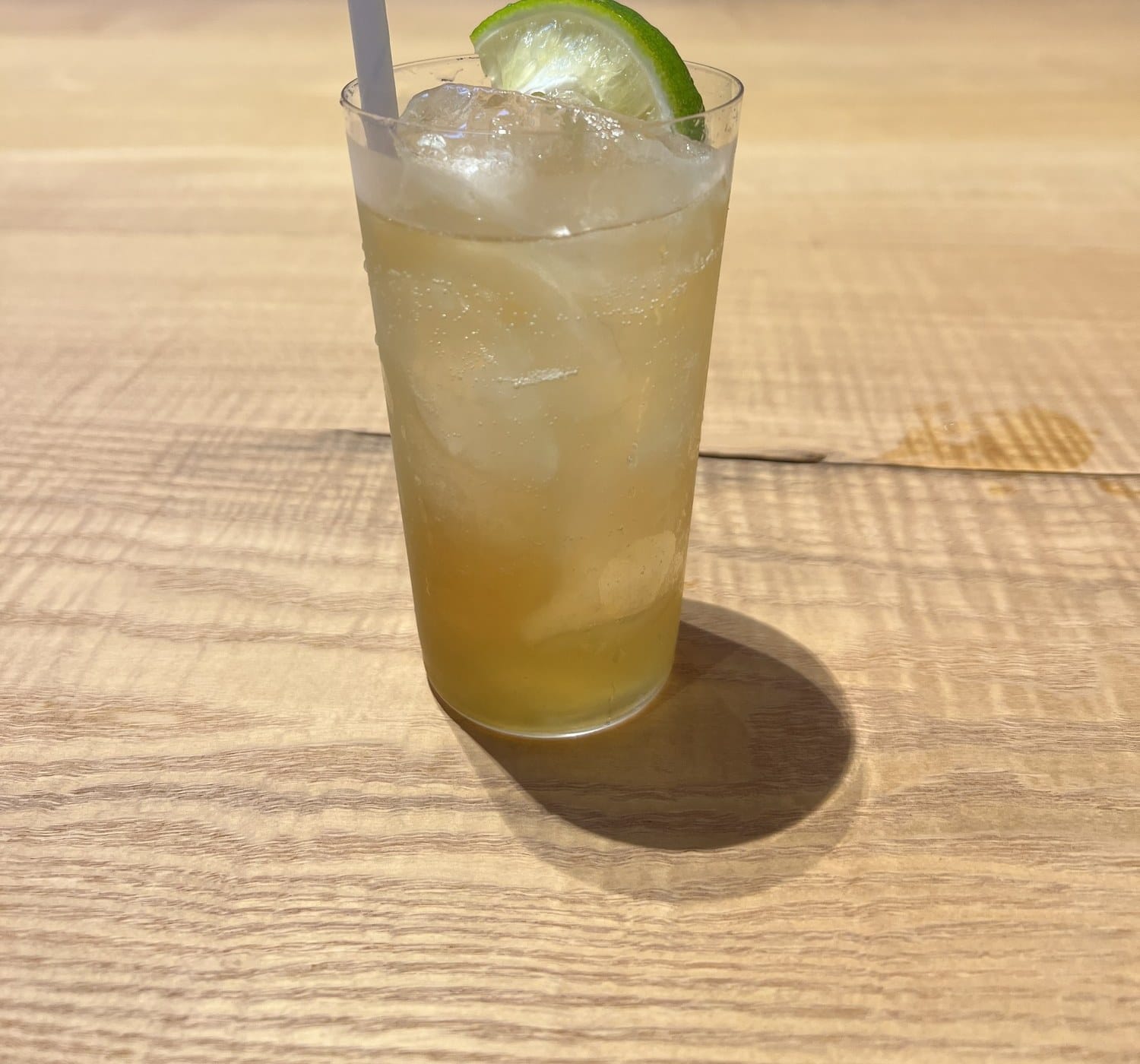 A gin highball with lime on the bar counter at Niseko Distillery