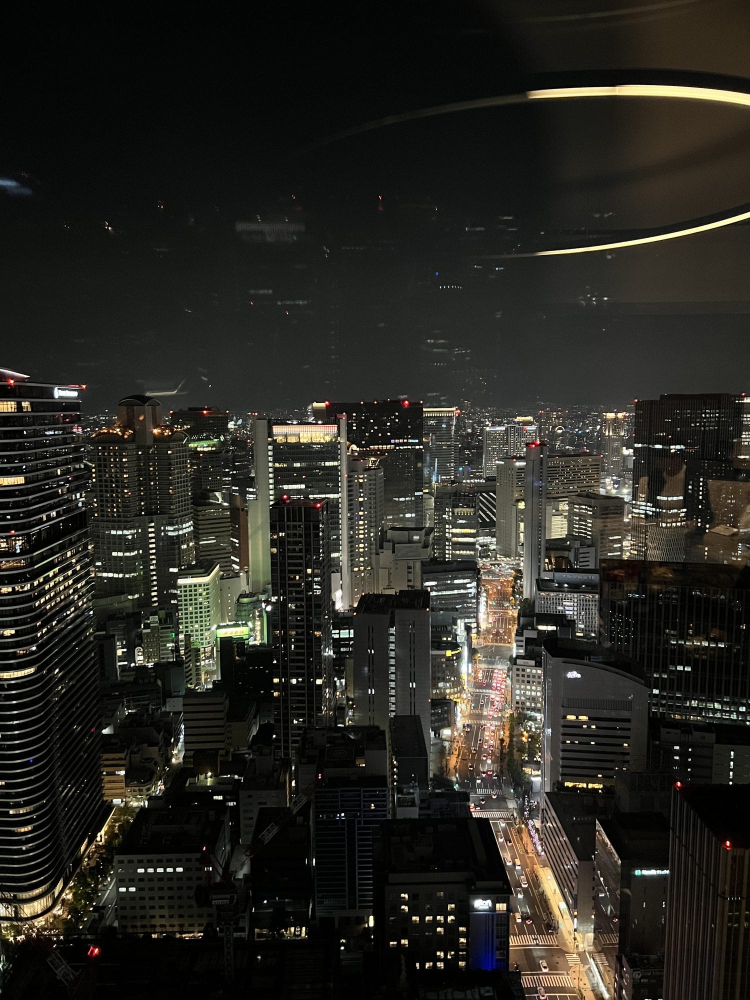 Osaka city skyline at night viewed from a high-rise hotel window