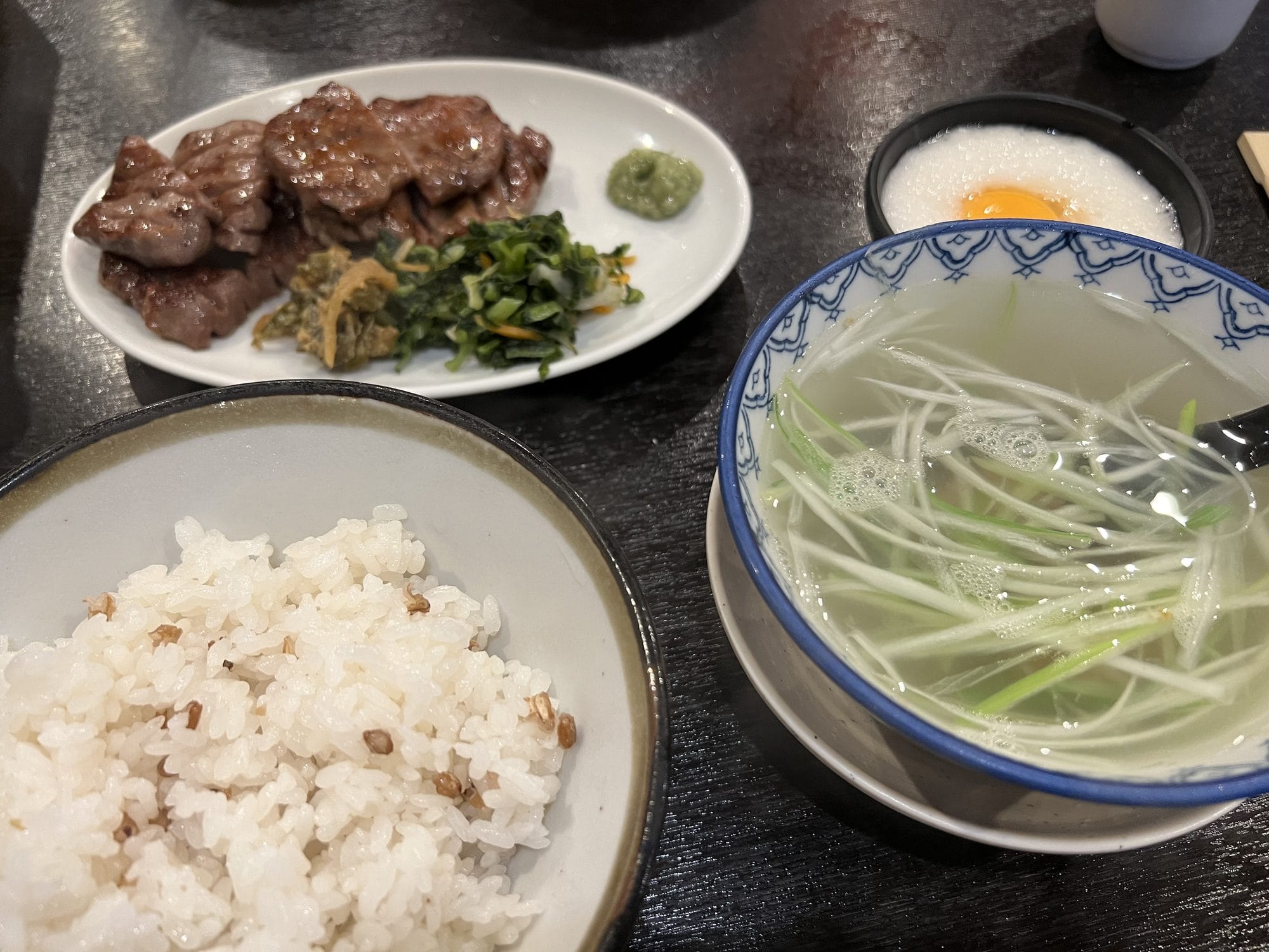Traditional gyutan beef tongue set meal with grilled tongue slices, barley rice, oxtail soup, and pickled vegetables — Sendai's signature dish