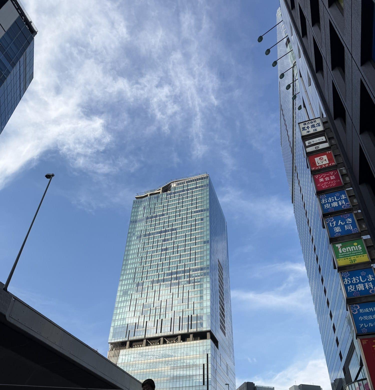 Looking up at Shibuya Scramble Square from street level near Shibuya Station