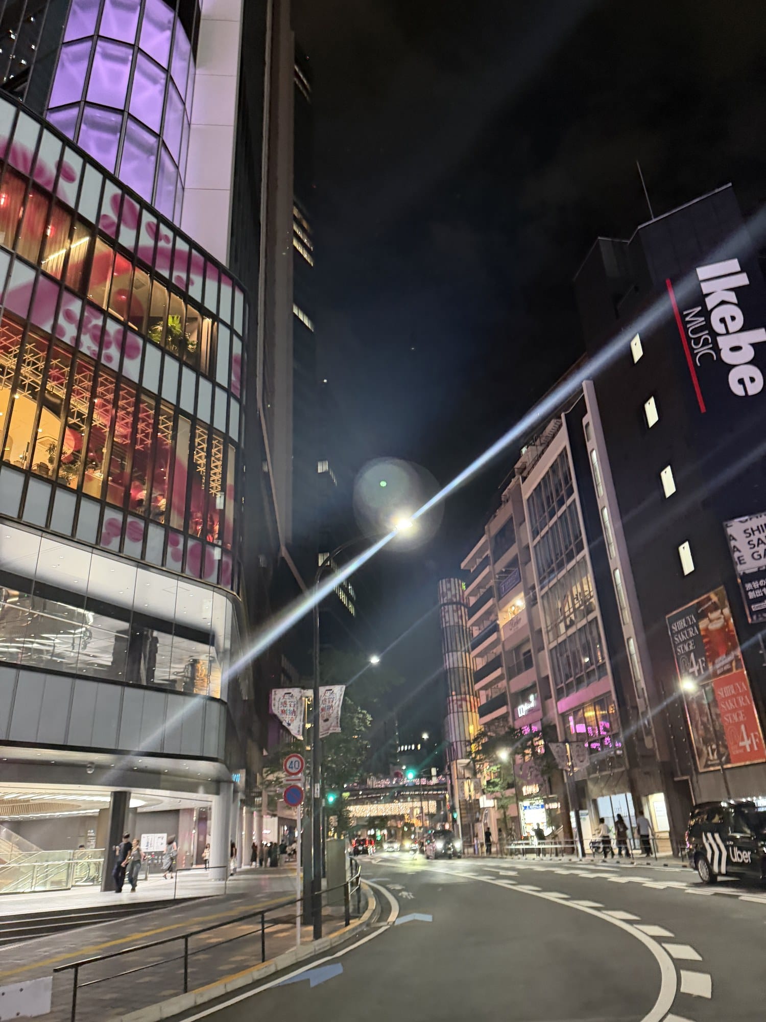 Neon-lit street near Sakuragaoka after dark, close to Shibuya Station