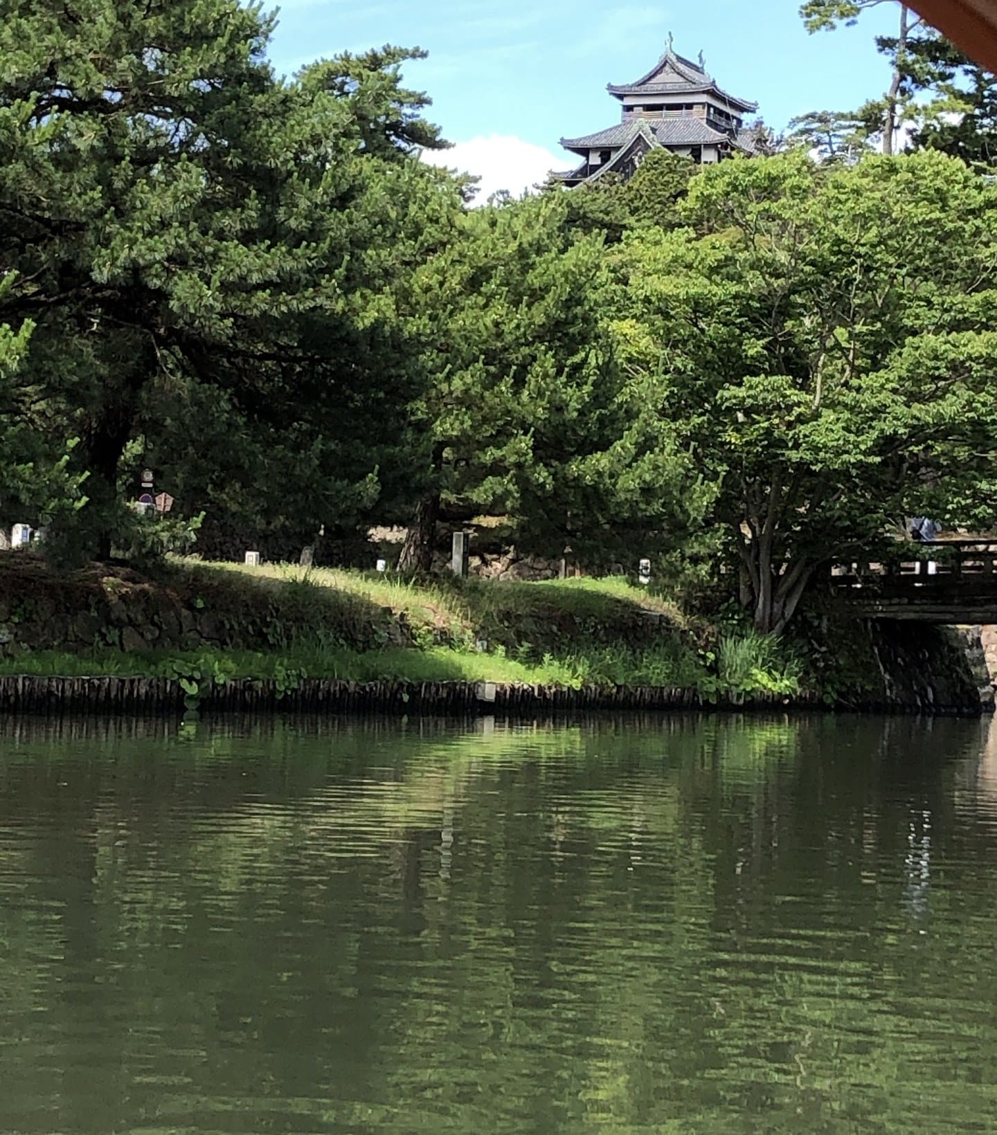 Matsue Castle keep seen across the moat from a Horikawa sightseeing boat