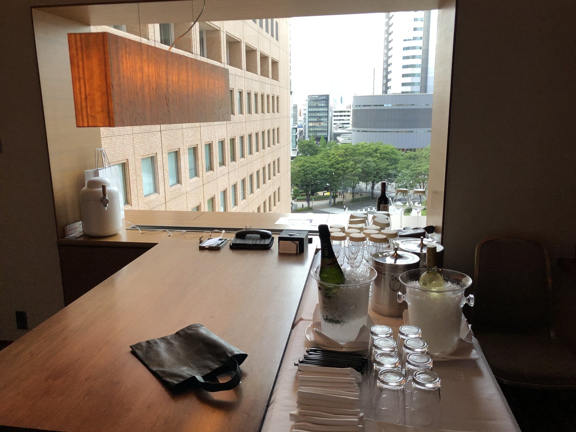 Drinks station inside Hilton Tokyo overlooking trees and office towers in Nishi-Shinjuku