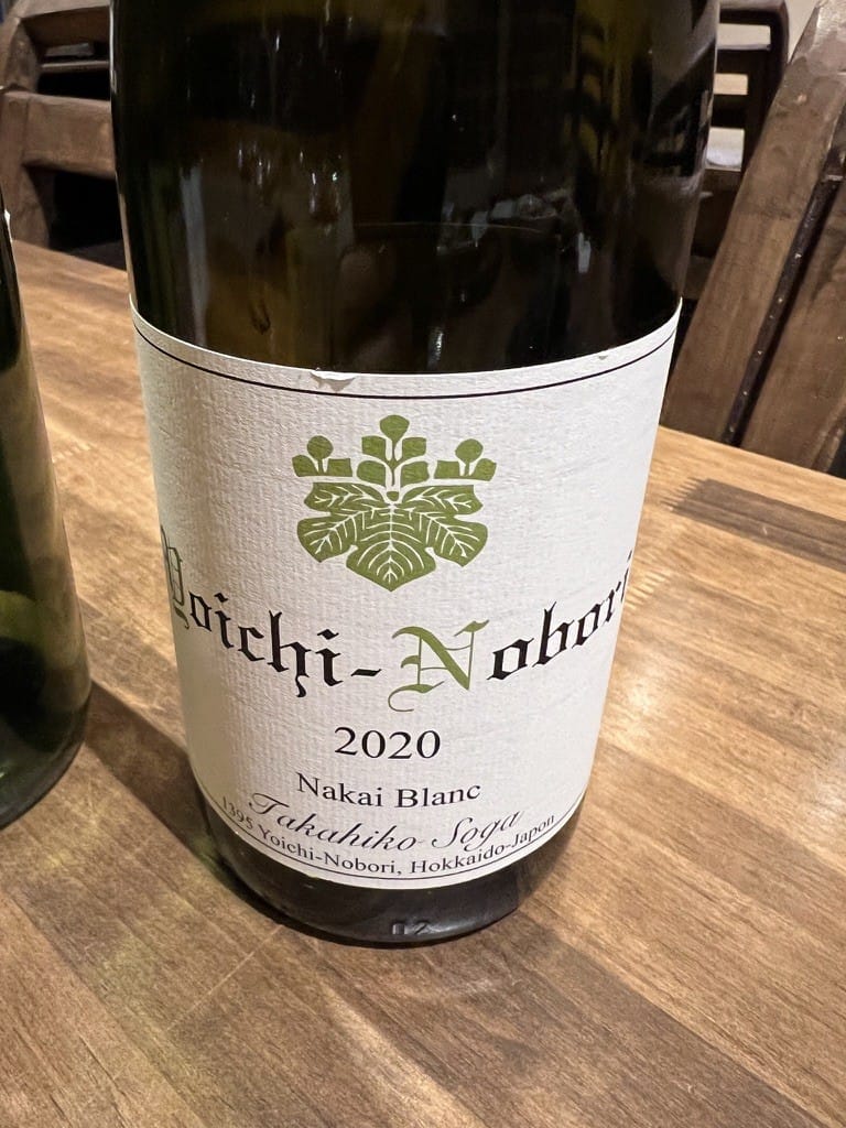 A bottle of Yoichi-Nobori Nakai Blanc 2020 by Domaine Takahiko Soga on a wooden table