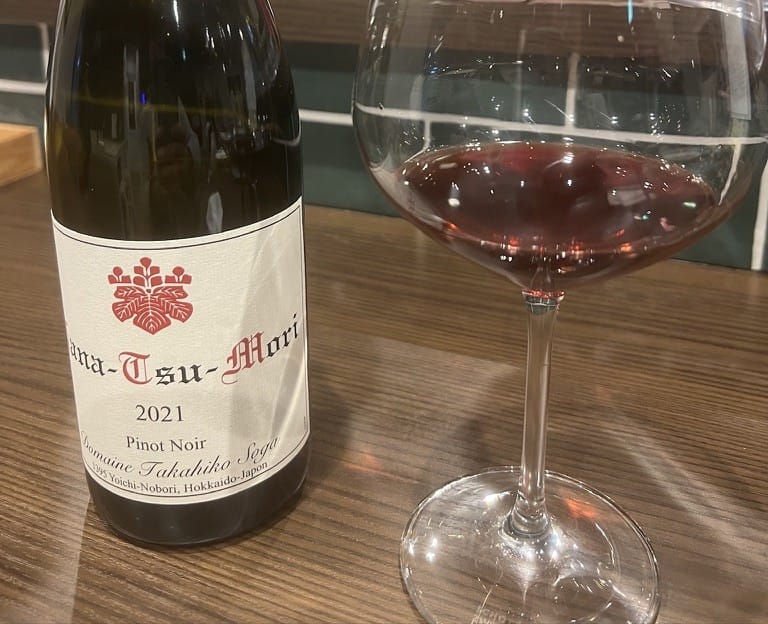 A bottle of Domaine Takahiko Nanatsu-Mori pinot noir being poured in Yoichi, Hokkaido
