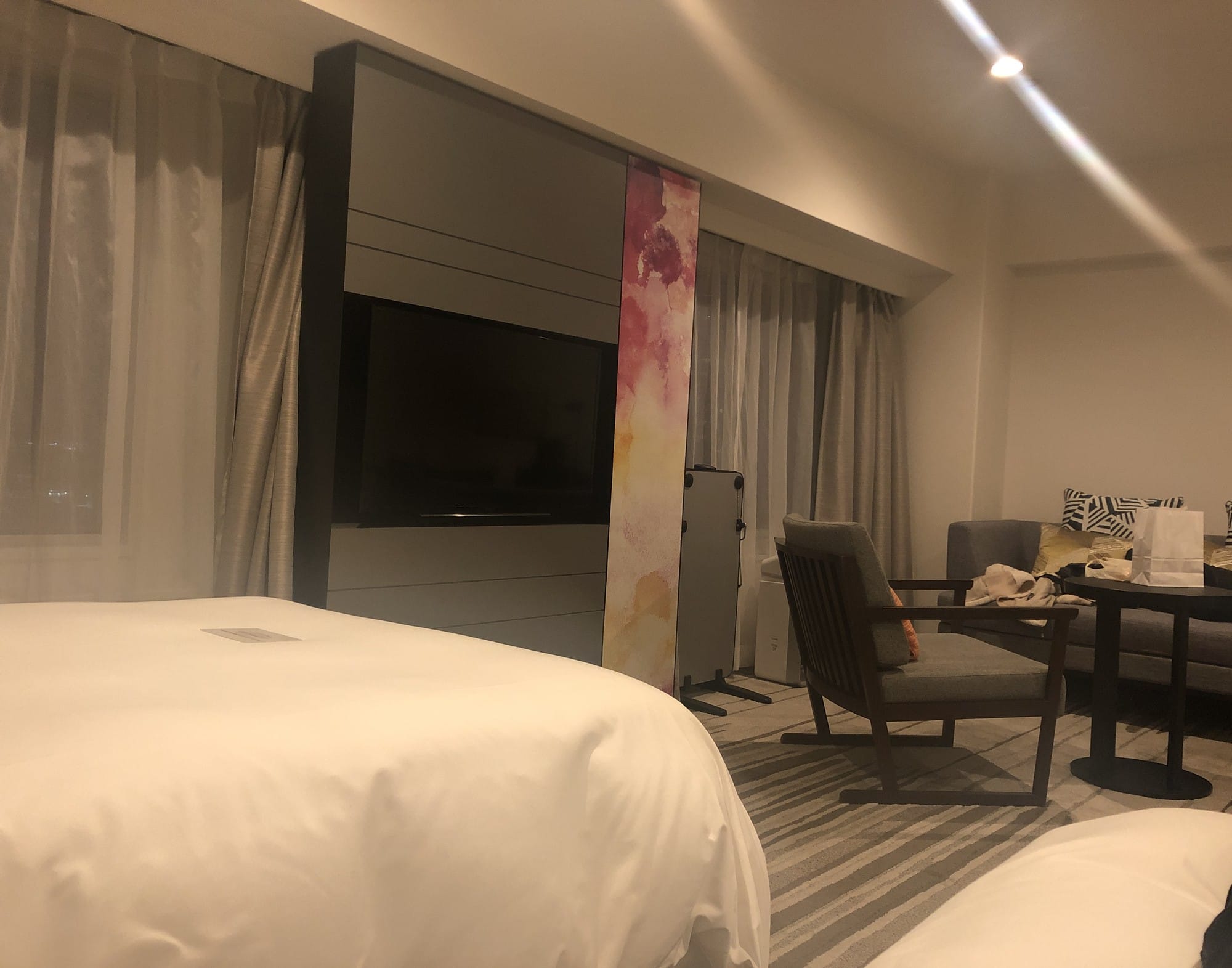 Corner room at ANA Crowne Plaza Sapporo with a double bed, sofa seating and a wall-mounted TV