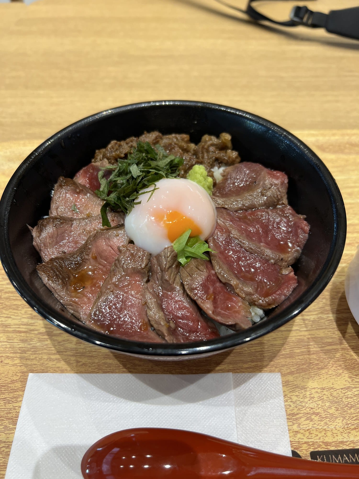 Akagyu beef bowl topped with a soft-poached egg at Aso Kumamoto Airport