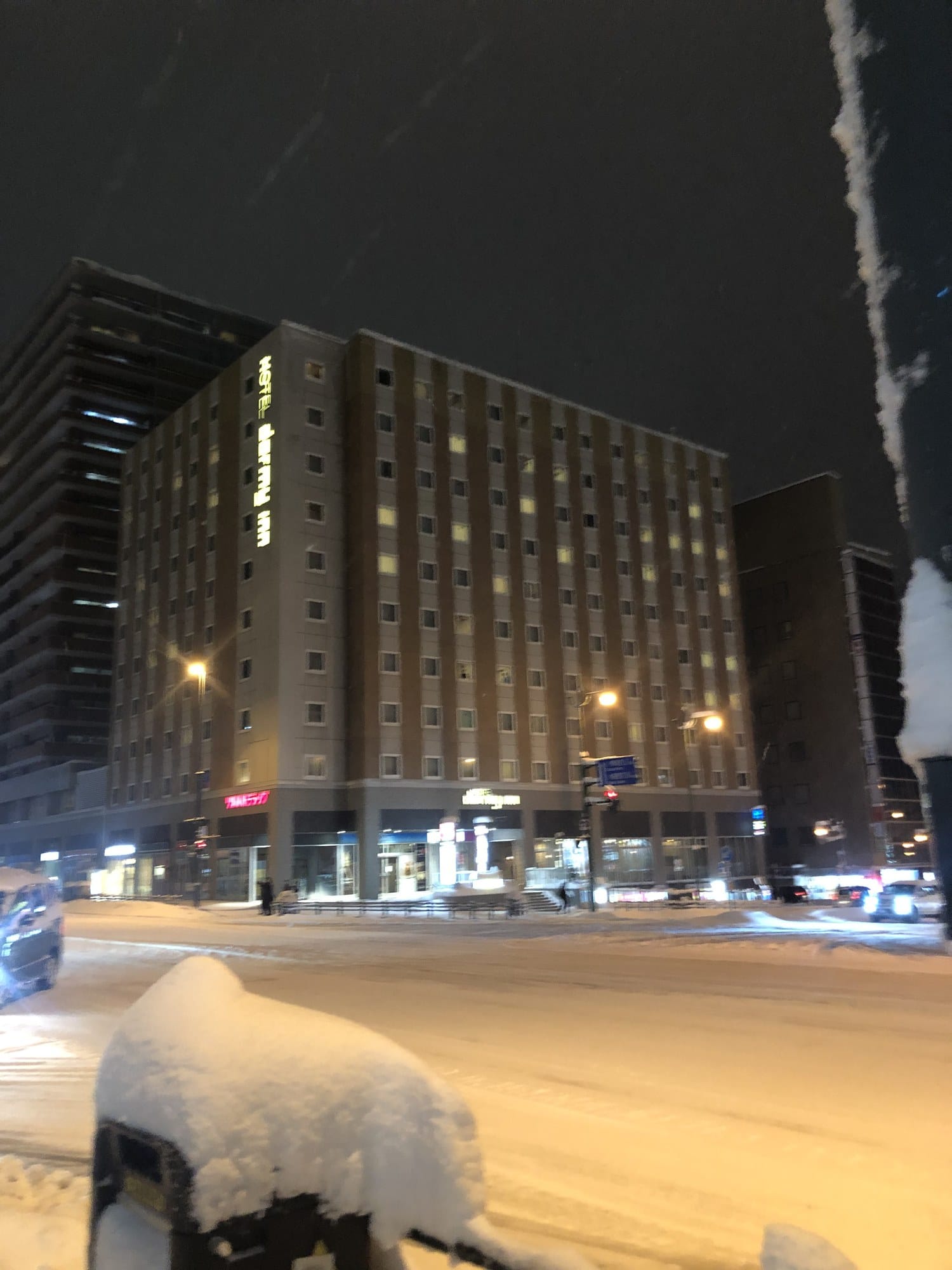 Snowy nighttime exterior of Dormy Inn PREMIUM Otaru in Hokkaido