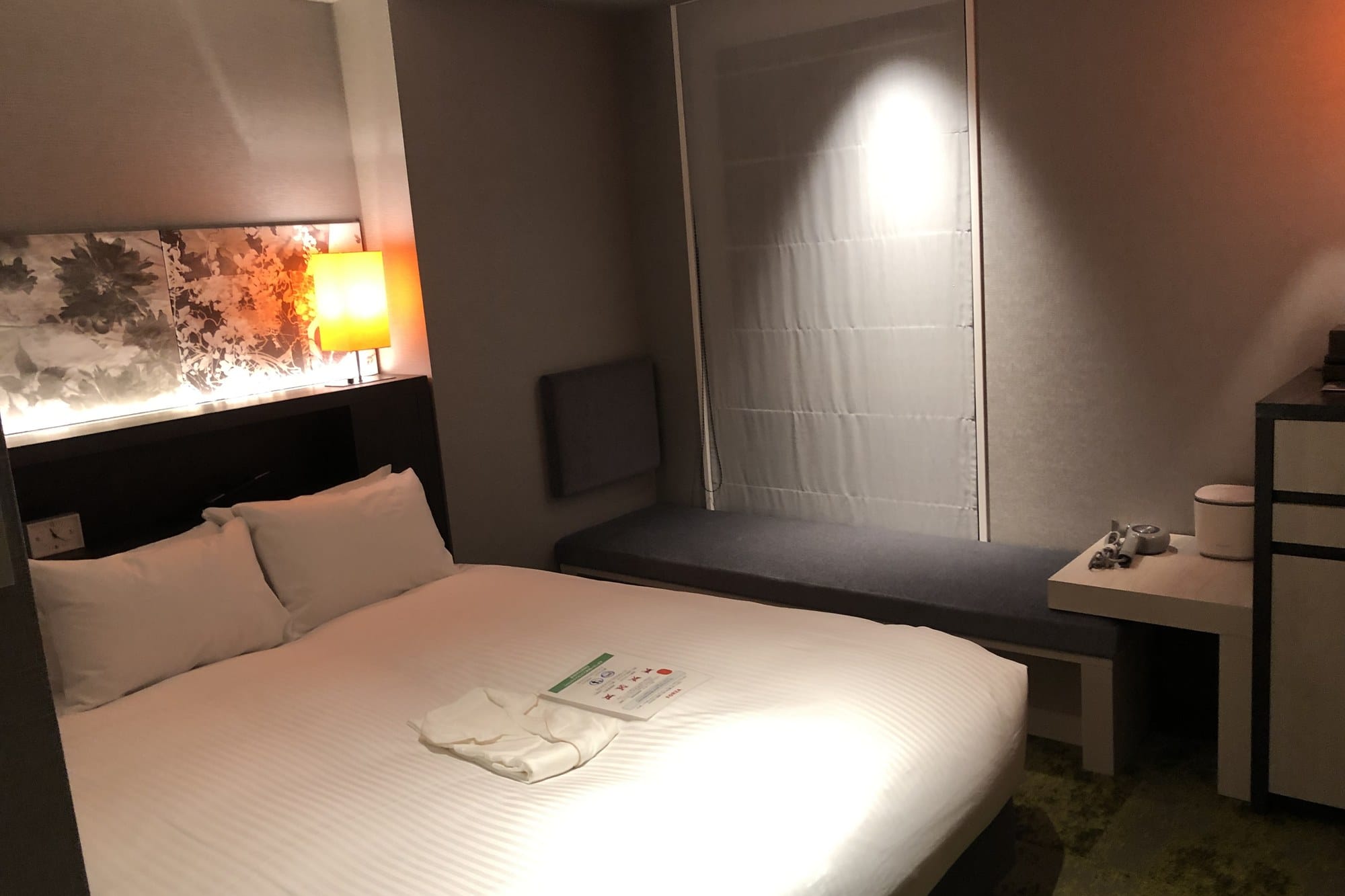 A compact hotel room at Hotel Forza Kyoto Shijo Kawaramachi with a double bed and warm lighting