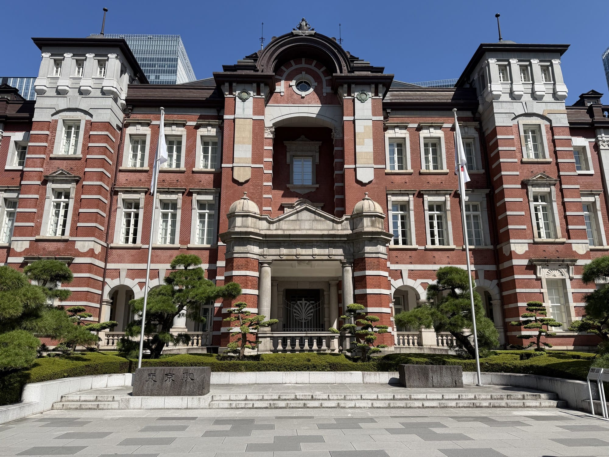 The restored red-brick Marunouchi building of Tokyo Station seen head-on from the plaza on a clear day