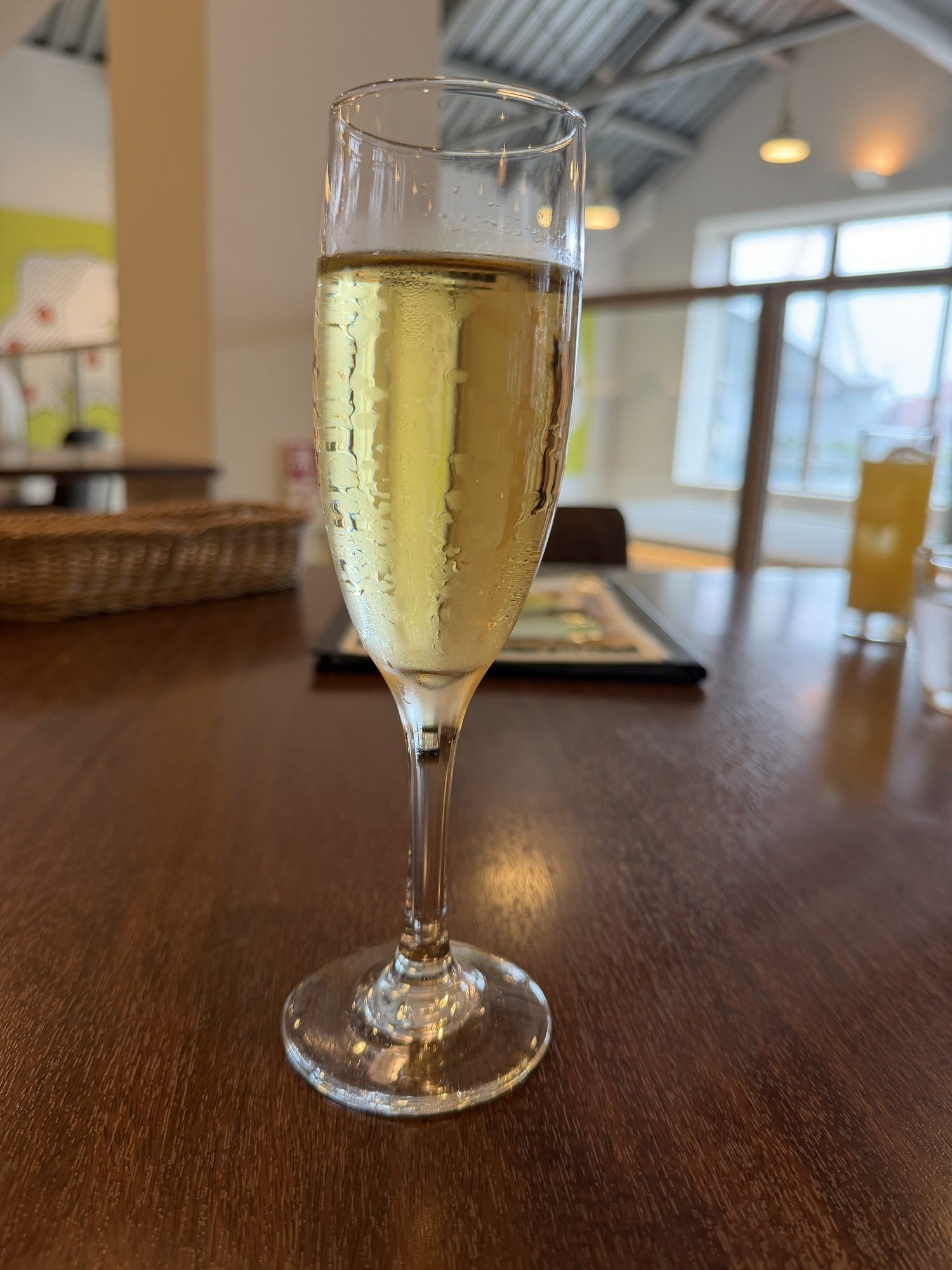 Glass of pale golden Aomori cider in a flute at A-FACTORY near Aomori Station