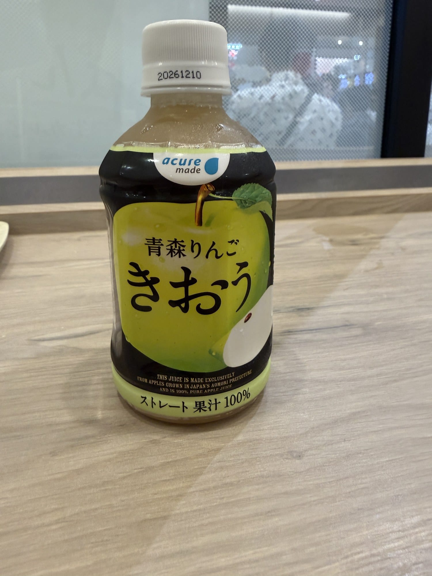 Bottle of acure made Aomori Kiou apple juice, straight-pressed 100 percent, with English text on the label