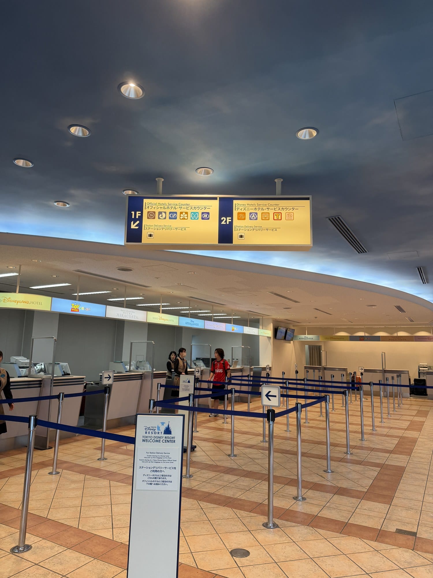 Service counters and queue lanes inside the Tokyo Disney Resort Welcome Center
