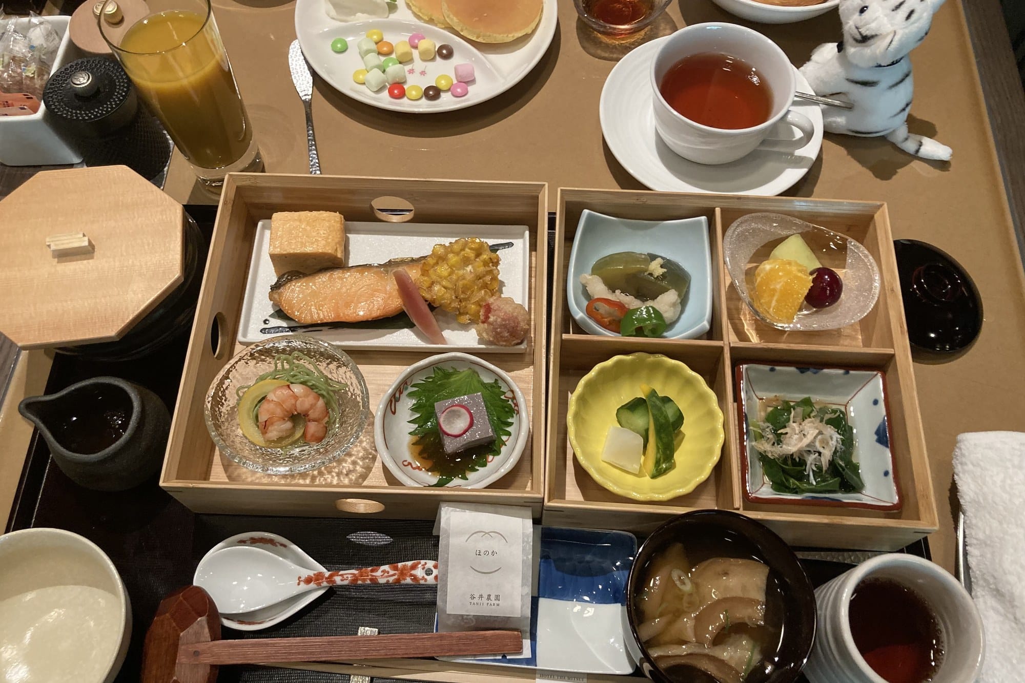 A Japanese breakfast at HOTEL THE MITSUI KYOTO served in a compartmented wooden box with grilled fish, small dishes, soup and tea