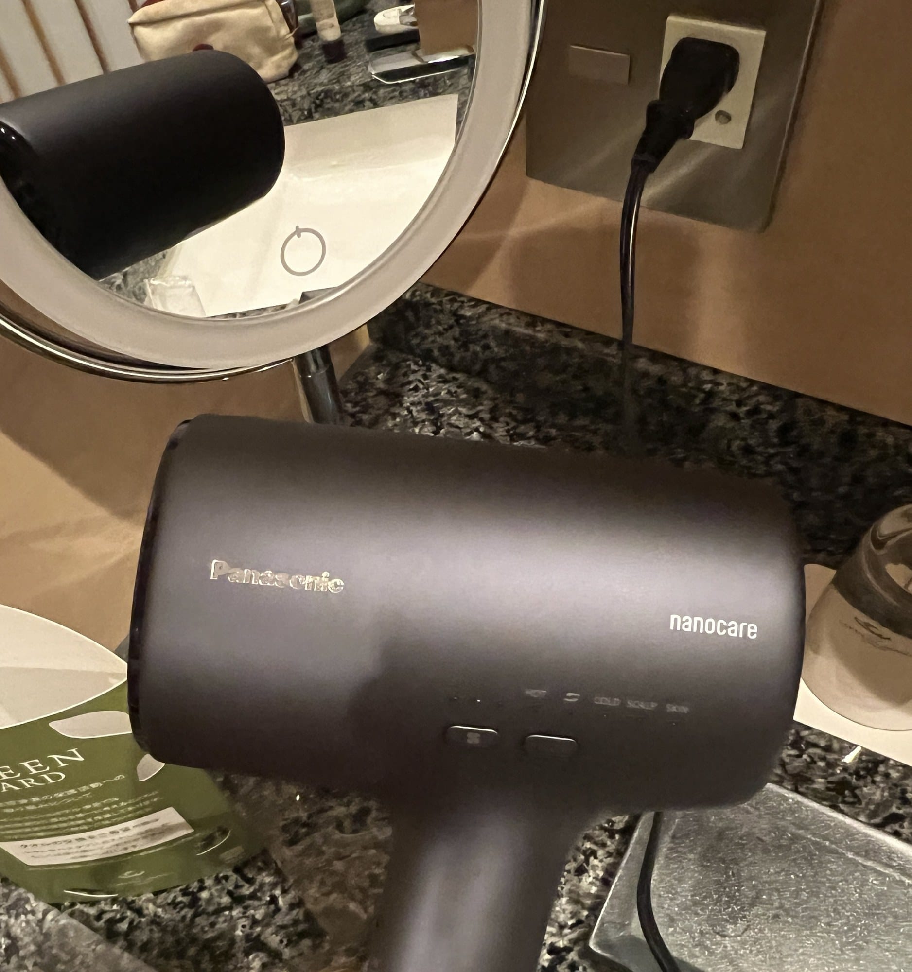 Panasonic nanocare hair dryer with HOT, COLD, SCALP and SKIN settings on the bathroom counter of a club-floor room