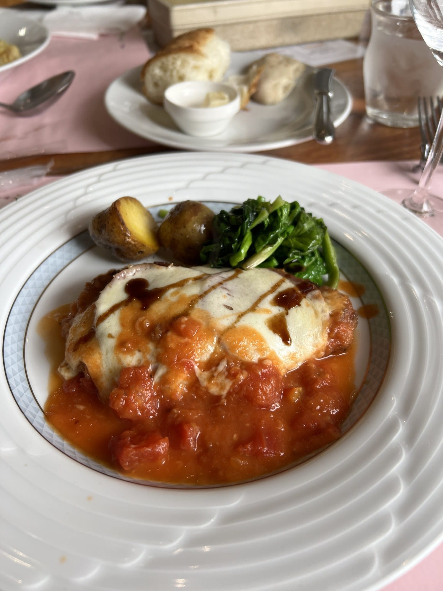 A breaded cutlet topped with tomato and mozzarella, with potato, at Il Piatto Nuovo in Otaru