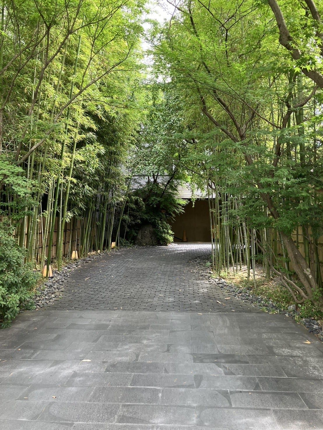 The stone-paved bamboo-lined approach to FUFU Kyoto in the Okazaki district