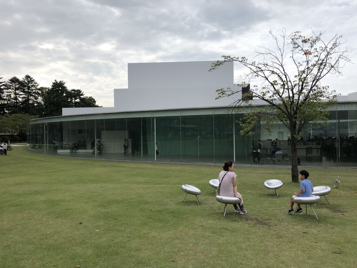Lawn and circular glass facade of the 21st Century Museum near Kenrokuen in Kanazawa