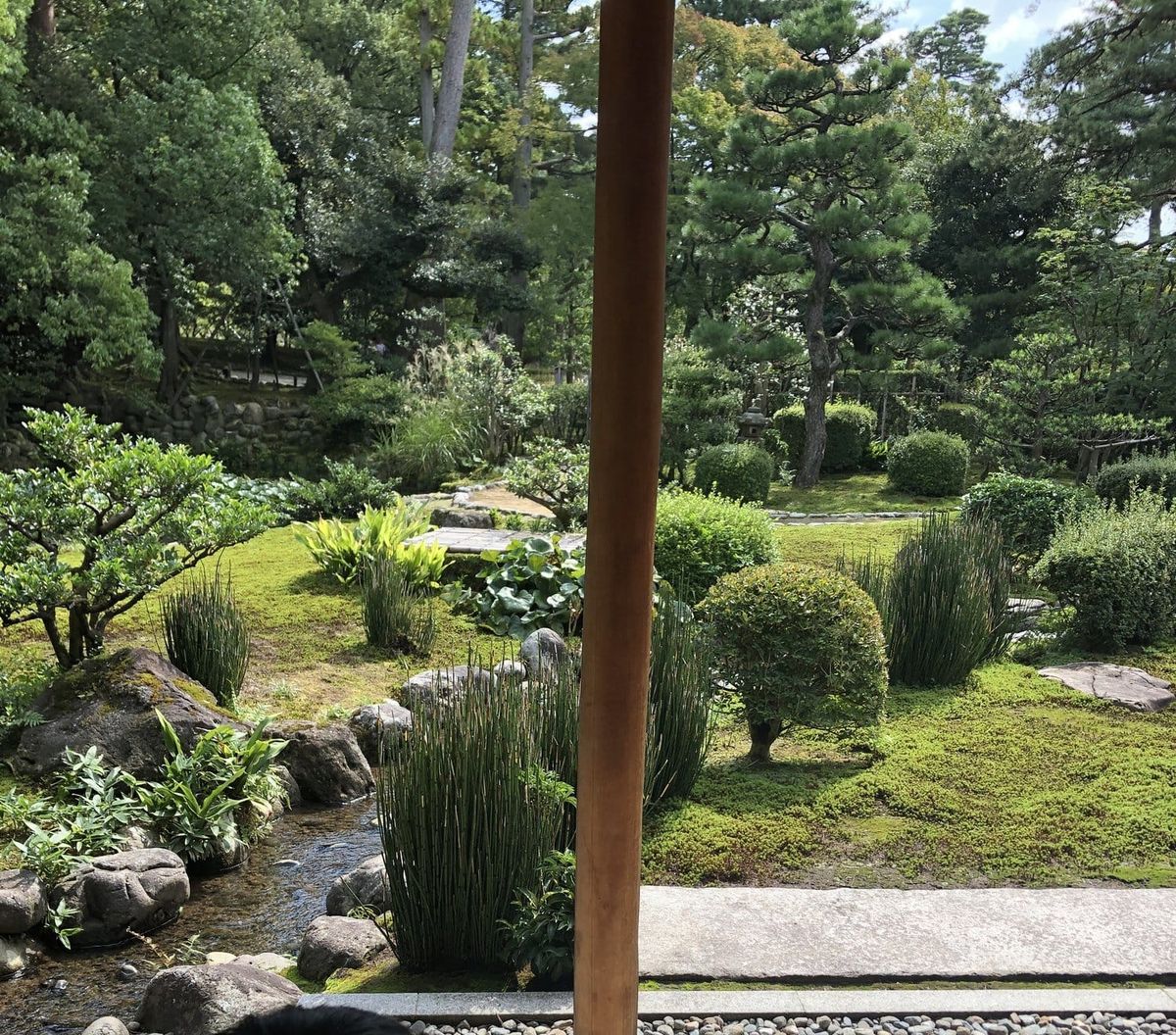 Temple garden with moss, stones and a stream in Kanazawa