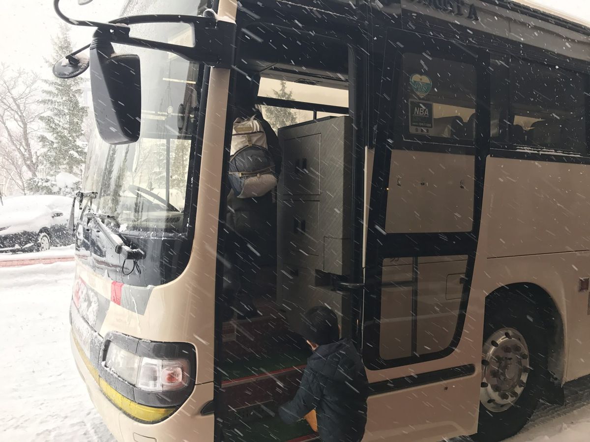 The Hokkaido Access Network ski bus at Kiroro, loading bags in snowfall