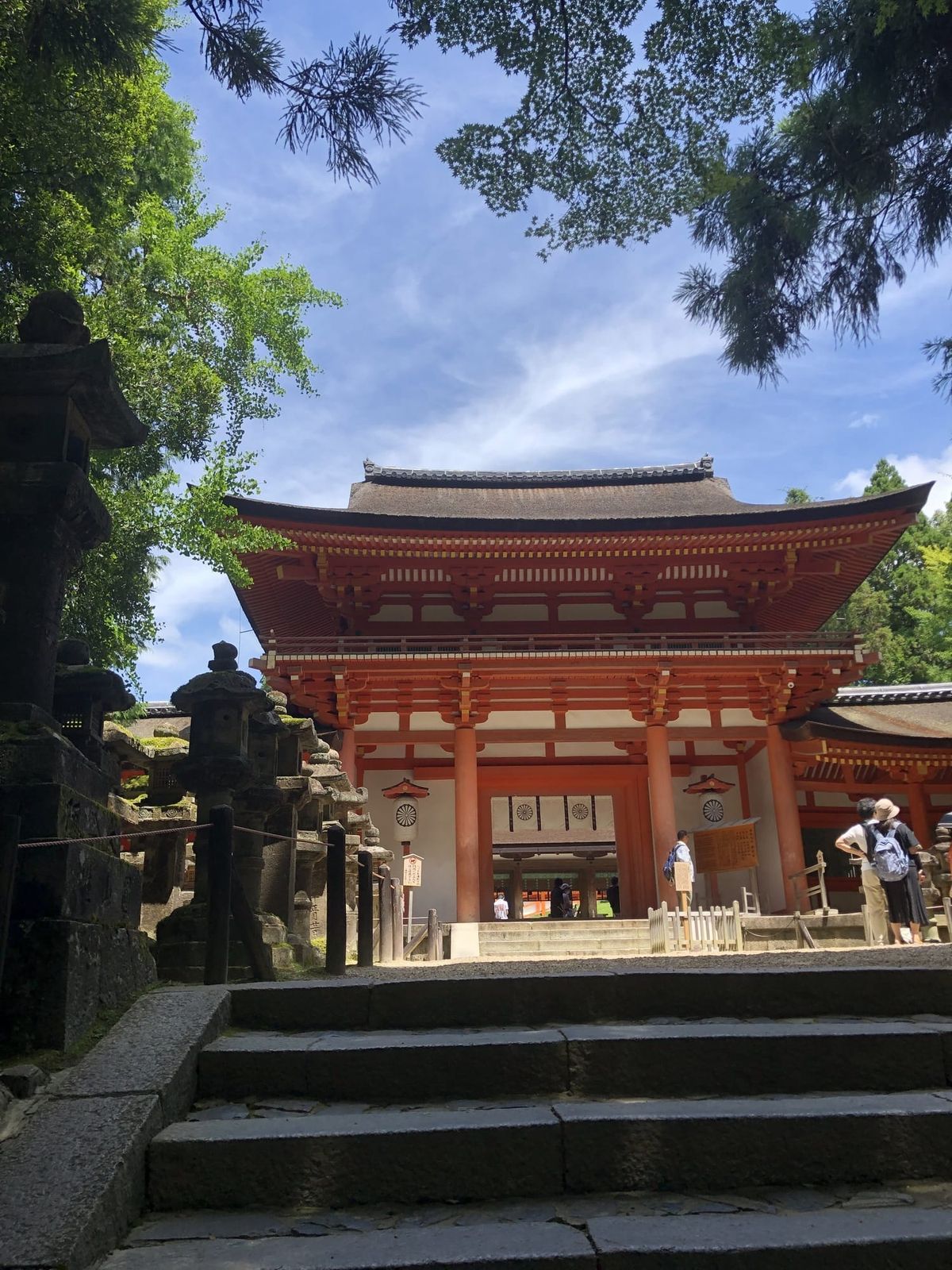 Vermilion shrine gate in Nara surrounded by trees