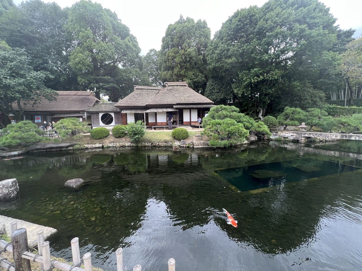 Thatched-roof teahouse and koi pond in Korakuen Garden, Okayama