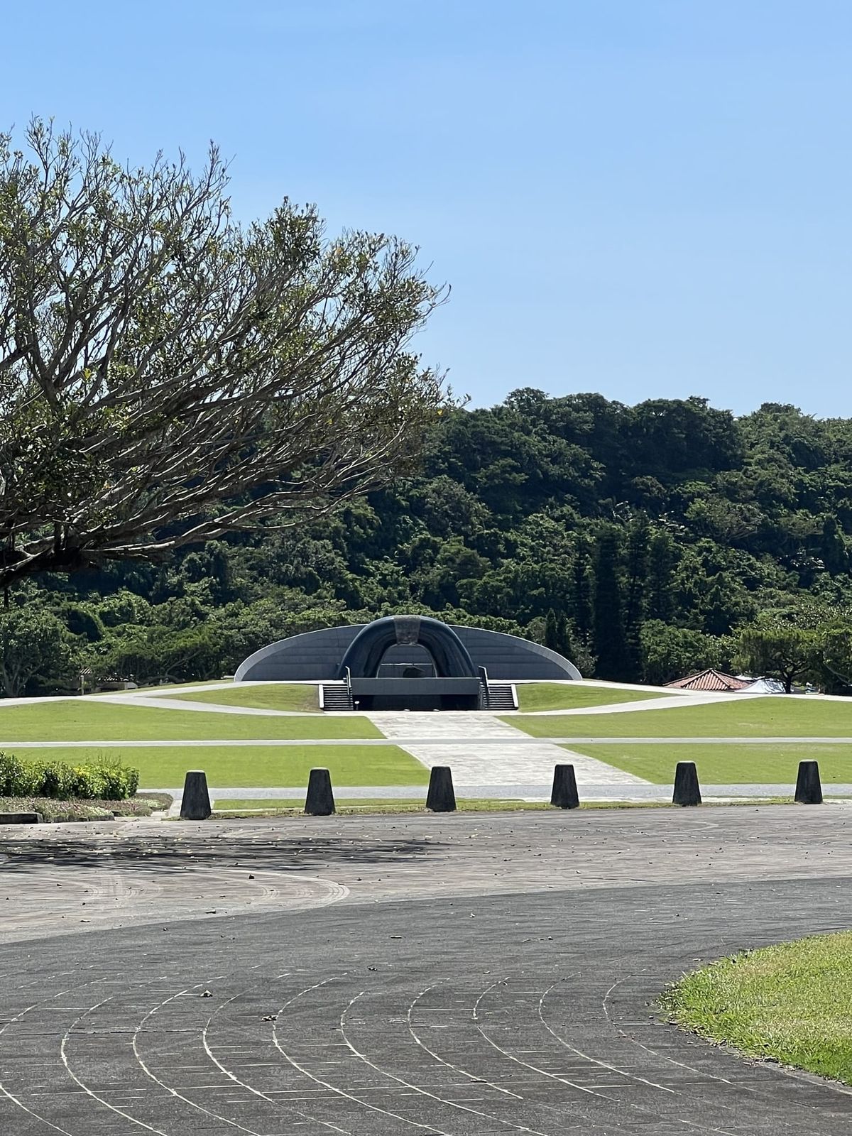 Peace memorial landscape in Okinawa with trees and blue sky