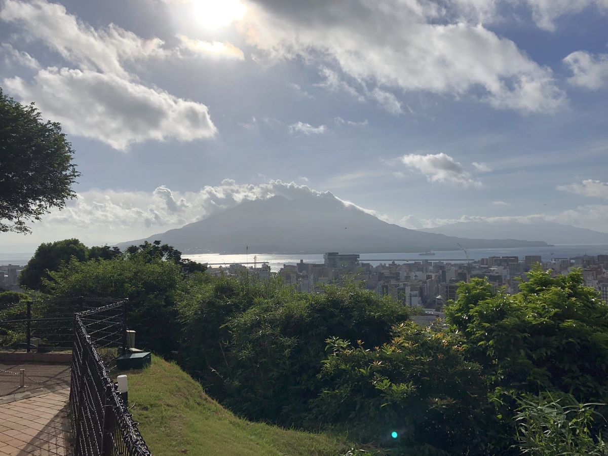 Sakurajima volcano across Kinko Bay, seen over the Kagoshima city skyline from the Shiroyama viewpoint