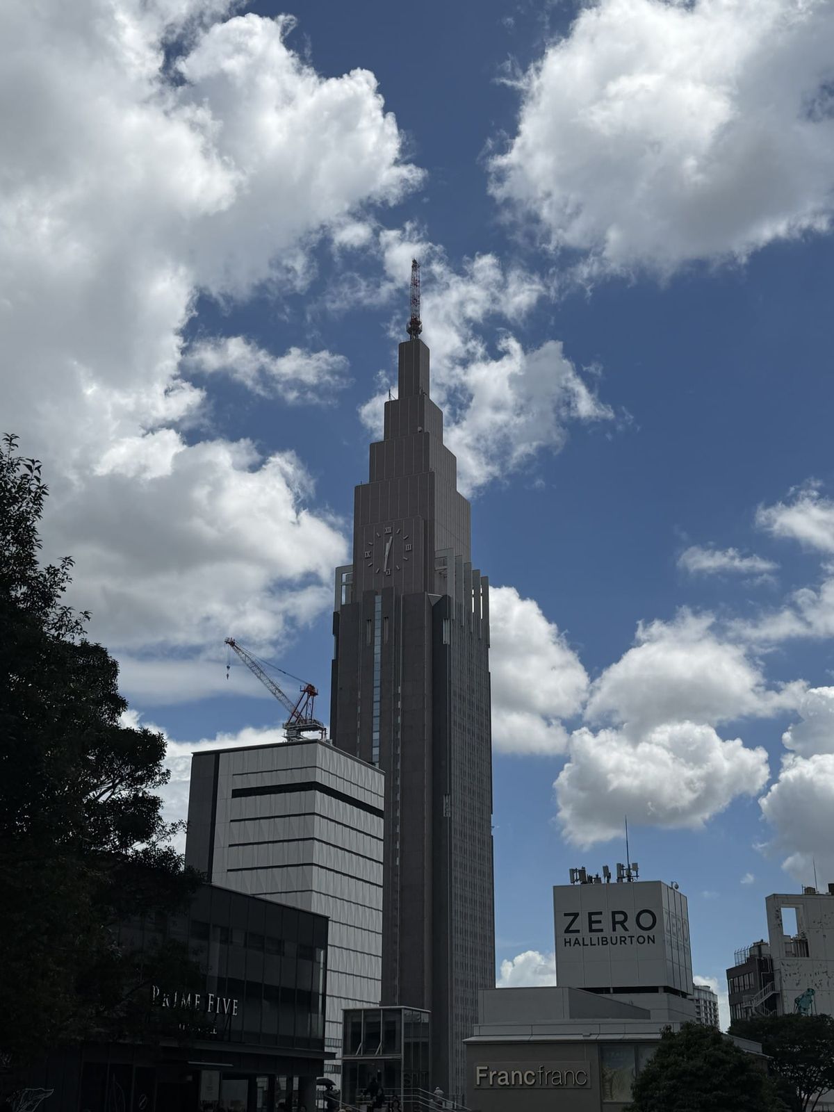 The NTT Docomo Yoyogi Building, the clock tower that marks Docomo's network, seen against a blue sky in Shinjuku, Tokyo