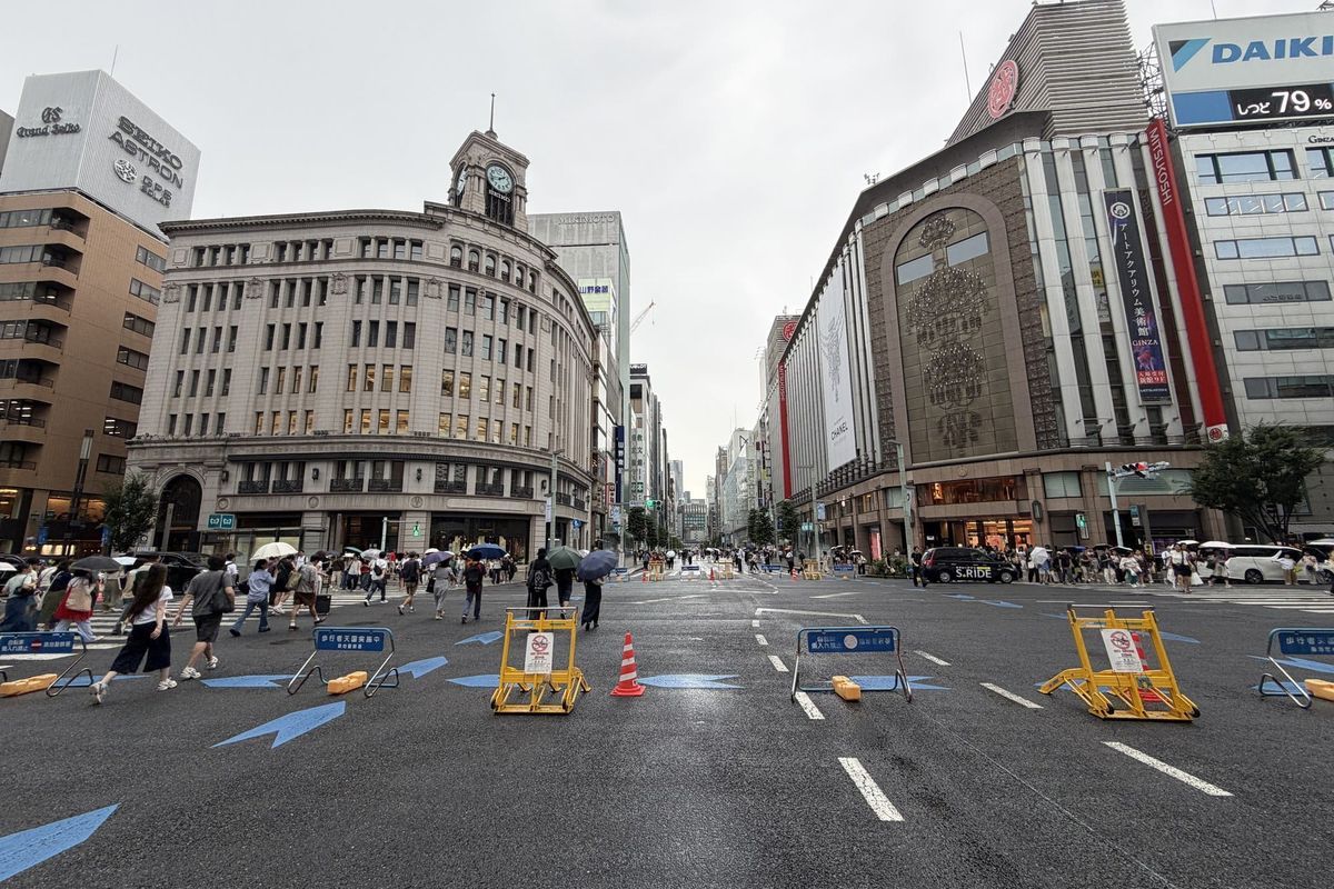 Chuo-dori in Ginza closed to traffic on a weekend afternoon, with the Wako clock tower at the 4-chome crossing