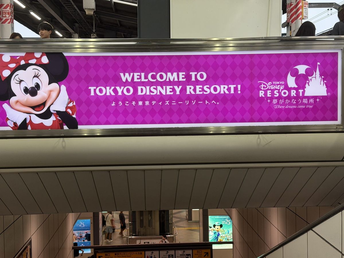 Welcome to Tokyo Disney Resort banner above the concourse at Maihama Station