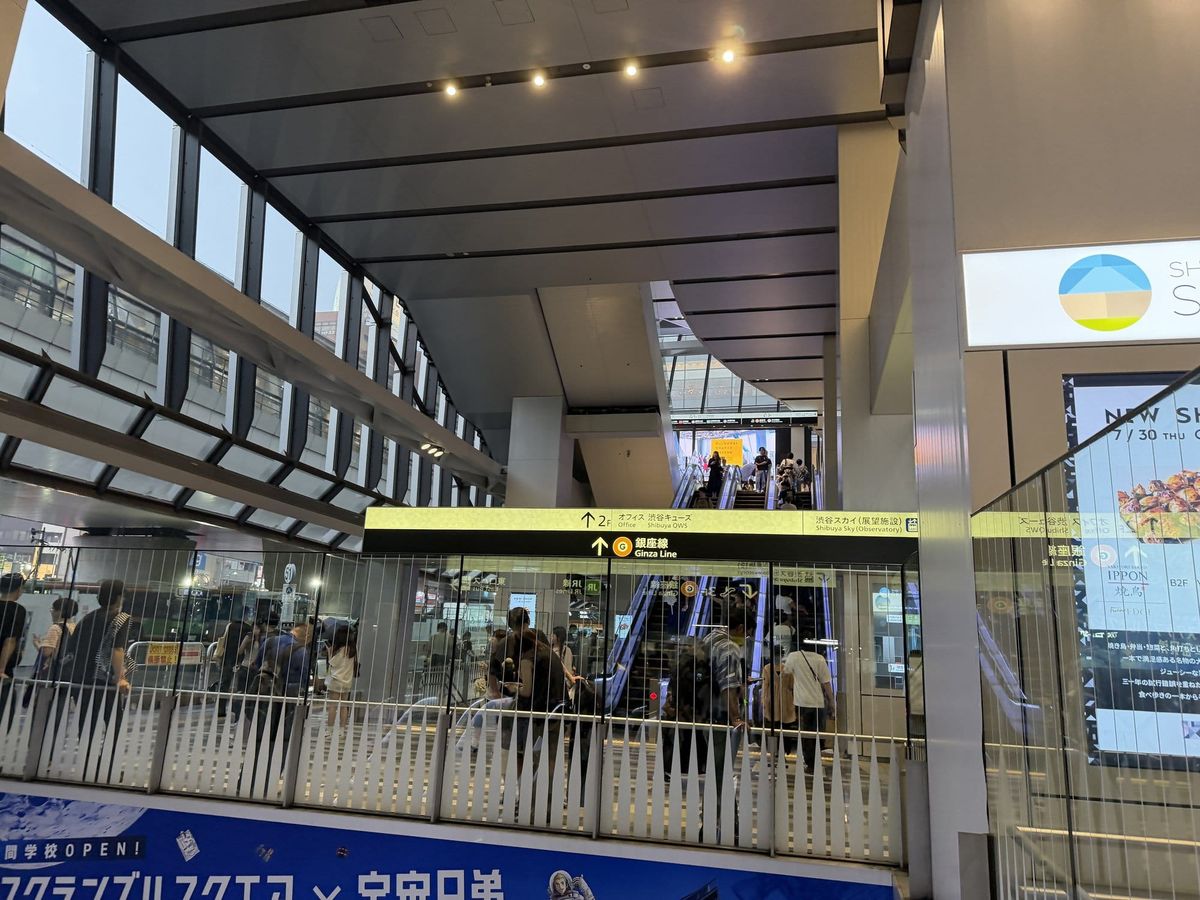Crowded escalators and concourse at the Shibuya Scramble Square building on a Saturday evening, Tokyo