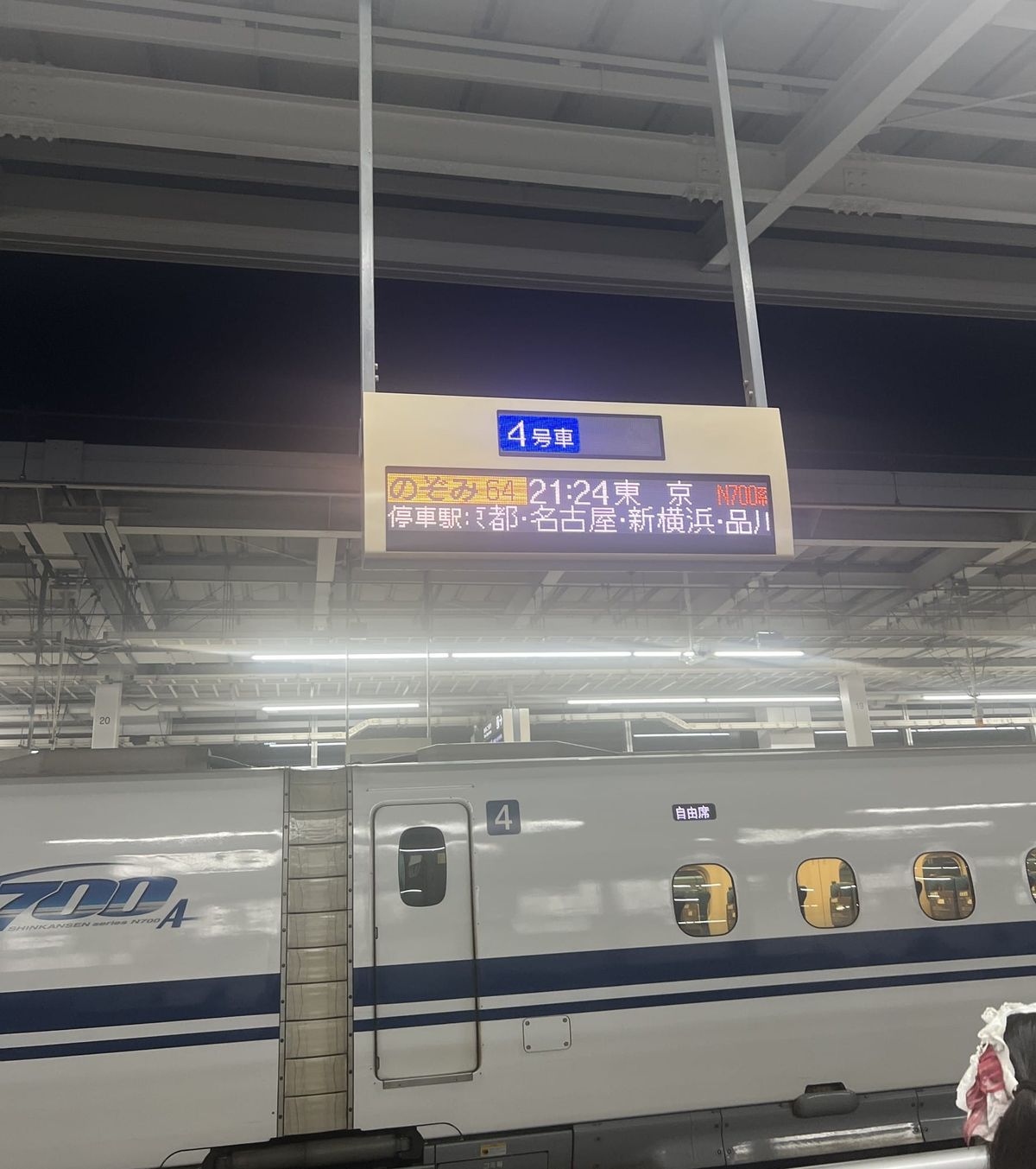 Nozomi departure board and an N700A shinkansen at Shin-Osaka Station platform