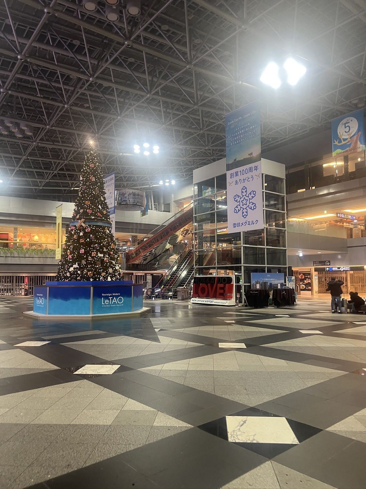 The atrium of New Chitose Airport in December with a large decorated tree