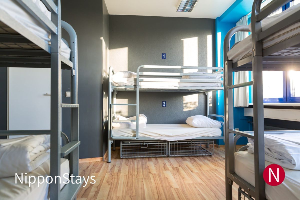 Metal bunk beds in an empty hostel dormitory