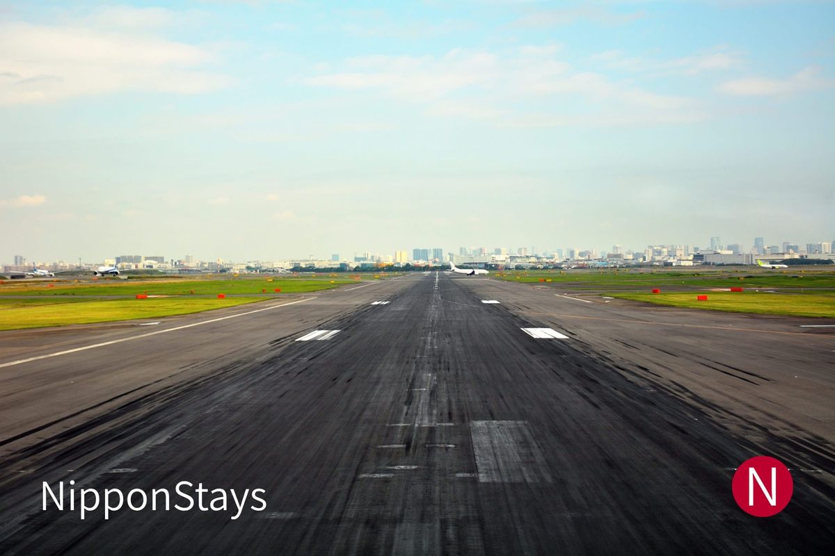 A runway at Haneda Airport under an open sky