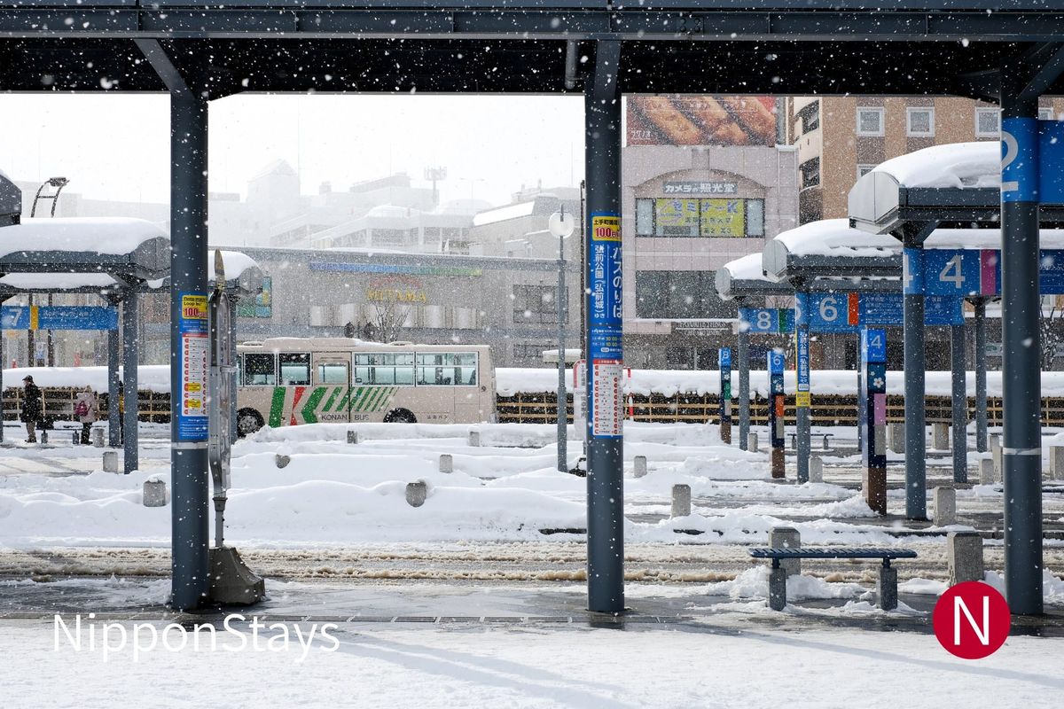 Covered bus bays under snow at a winter bus terminal in northern Japan