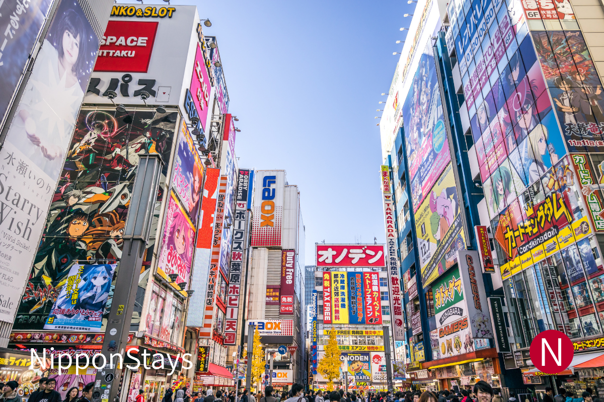 Akihabara Electric Town streets lined with anime and electronics signs near the station.